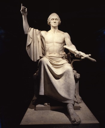 Marble statue of Washington seated with raised right arm and bare torso, holding a sheathed sword in his left hand.