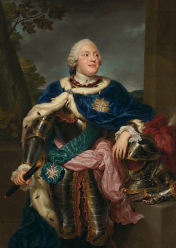 A young man is draped in fine clothing.